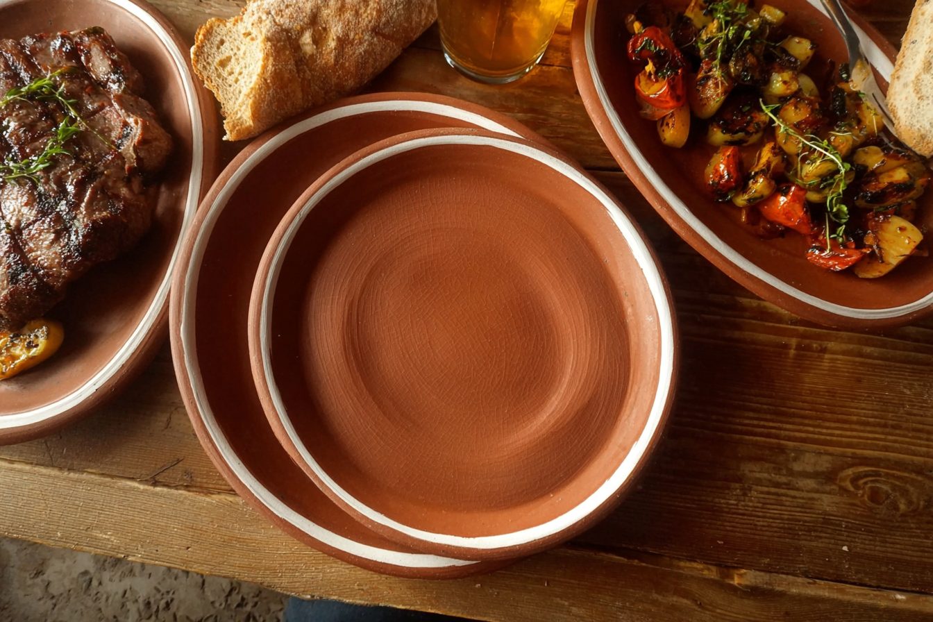 Red clay steak plate in restaurant service
